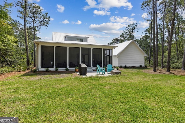 105 Whispering Oaks Ln, Saint Marys, GA 31558 - back of house with a patio area, metal roof, a sunroom, and a lawn