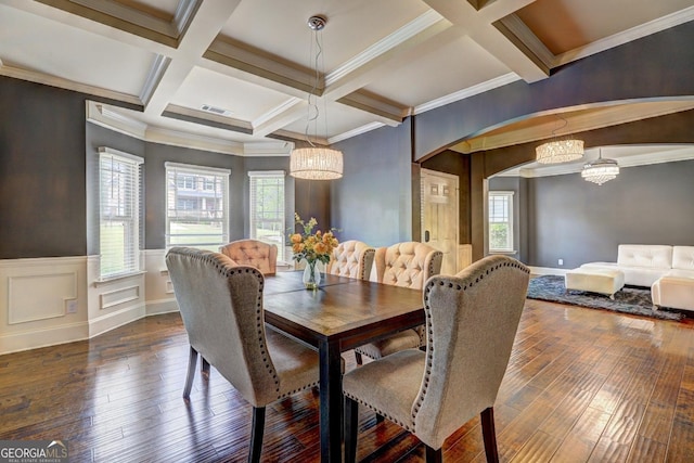 dining room featuring a chandelier, arched walkways, and hardwood / wood-style flooring