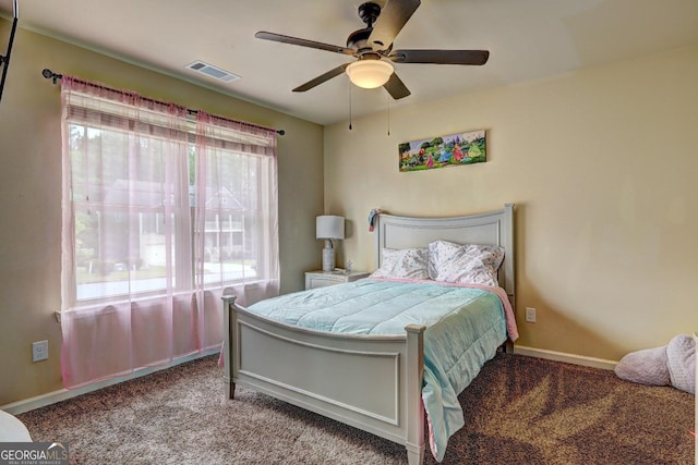 carpeted bedroom featuring visible vents, baseboards, and a ceiling fan