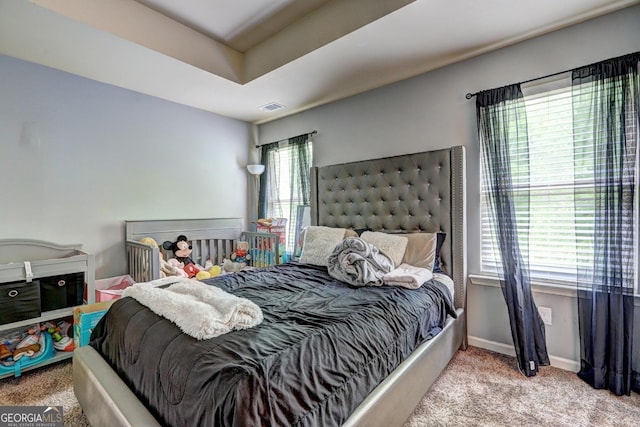 bedroom with visible vents, baseboards, and carpet