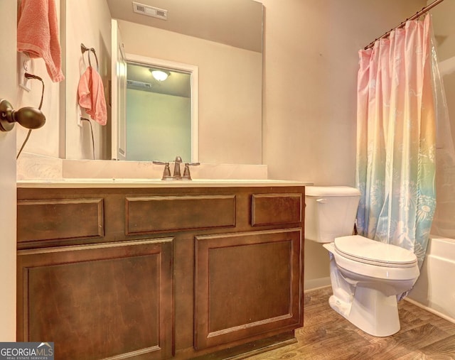 full bathroom featuring shower / bath combo, visible vents, toilet, vanity, and wood finished floors