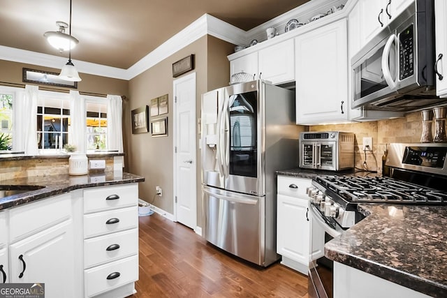 561 Valleyside Dr, Dallas, GA 30157 - kitchen with appliances with stainless steel finishes, white cabinetry, decorative backsplash, crown molding, and dark wood-type flooring