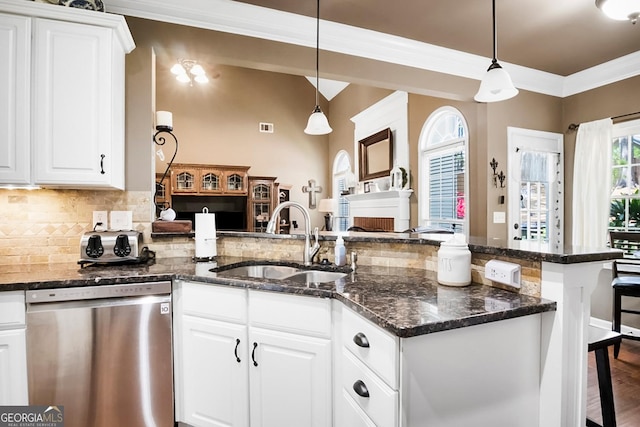561 Valleyside Dr, Dallas, GA 30157 - kitchen featuring dishwasher, a sink, a breakfast bar area, white cabinetry, and crown molding