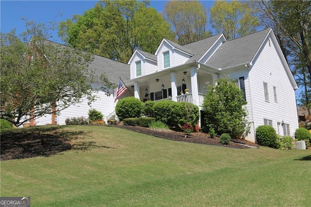 view of side of property with a lawn and a porch