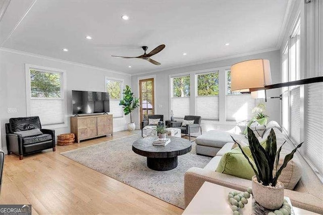 living area with crown molding, wood finished floors, ceiling fan, and recessed lighting