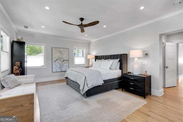bedroom featuring light wood-style floors, multiple windows, and visible vents