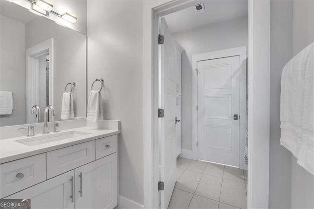 bathroom with vanity, baseboards, tile patterned flooring, and visible vents