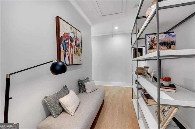 sitting room with baseboards, recessed lighting, attic access, and wood finished floors