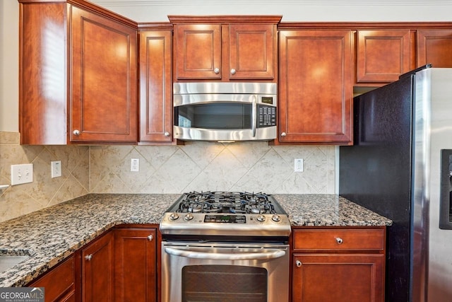 kitchen with dark brown cabinets, backsplash, and appliances with stainless steel finishes
