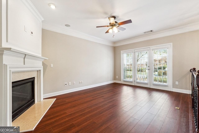 unfurnished living room with baseboards, ceiling fan, crown molding, dark wood-type flooring, and a premium fireplace