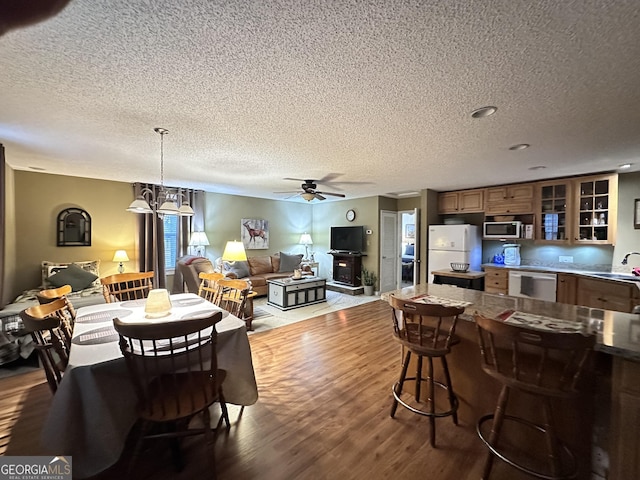 80 Hill Farm Rd, Alamo, GA 30411 - dining area with a textured ceiling, ceiling fan, wood finished floors, and a chandelier