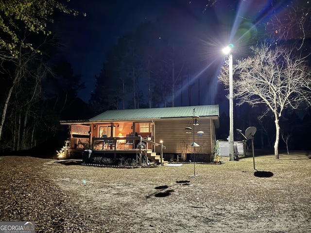 80 Hill Farm Rd, Alamo, GA 30411 - back of house at twilight with metal roof and a porch