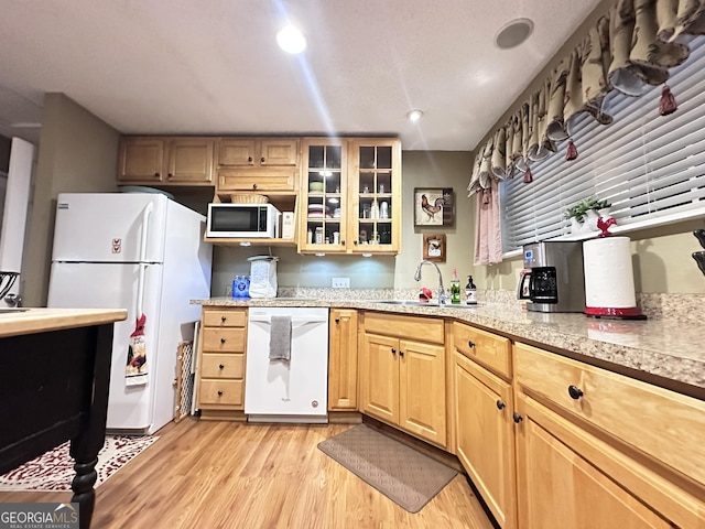 80 Hill Farm Rd, Alamo, GA 30411 - kitchen with white appliances, a sink, light countertops, light wood-style floors, and glass insert cabinets