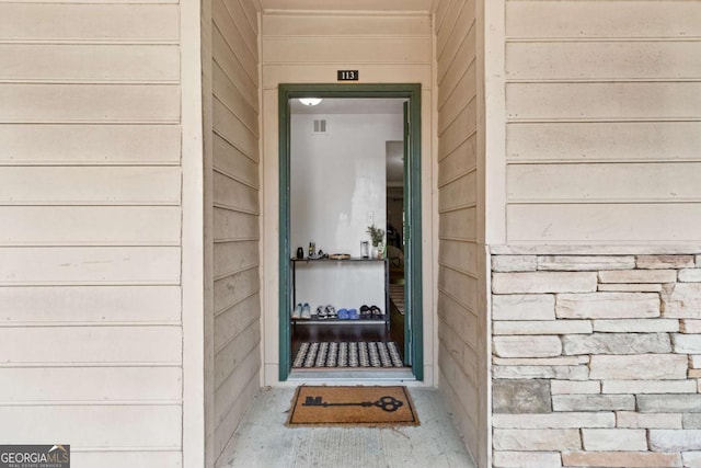 113 Brittany Ct, Duluth, GA 30096 - doorway to property with stone siding and visible vents