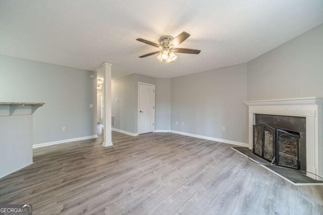 29 Monte Ln, Jefferson, GA 30549 - unfurnished living room with a ceiling fan, wood finished floors, and a fireplace with raised hearth