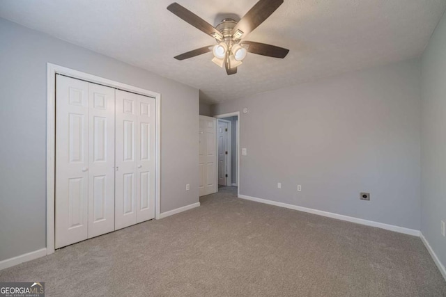29 Monte Ln, Jefferson, GA 30549 - unfurnished bedroom featuring carpet, a closet, and a ceiling fan