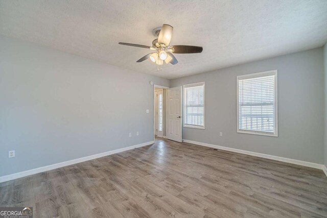 29 Monte Ln, Jefferson, GA 30549 - unfurnished room featuring wood finished floors, a ceiling fan, and a textured ceiling