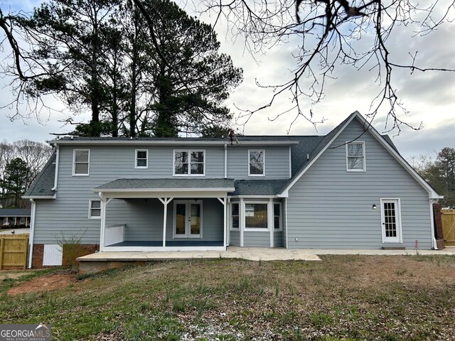 22 Edgewood Dr, Carrollton, GA 30116 - back of house featuring a lawn, a patio, roof with shingles, fence, and french doors