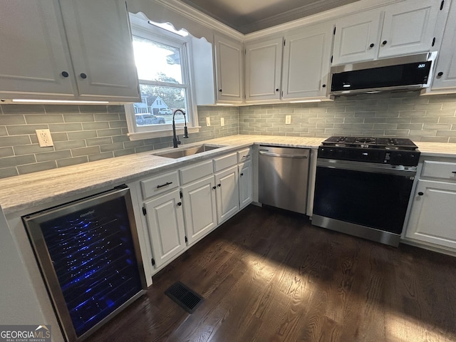 22 Edgewood Dr, Carrollton, GA 30116 - kitchen with a sink, wine cooler, white cabinetry, stainless steel appliances, and dark wood-type flooring