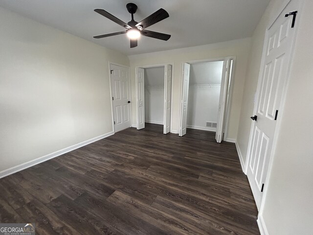 22 Edgewood Dr, Carrollton, GA 30116 - unfurnished bedroom featuring visible vents, baseboards, ceiling fan, dark wood-style floors, and multiple closets
