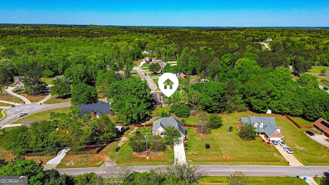 bird's eye view with a wooded view