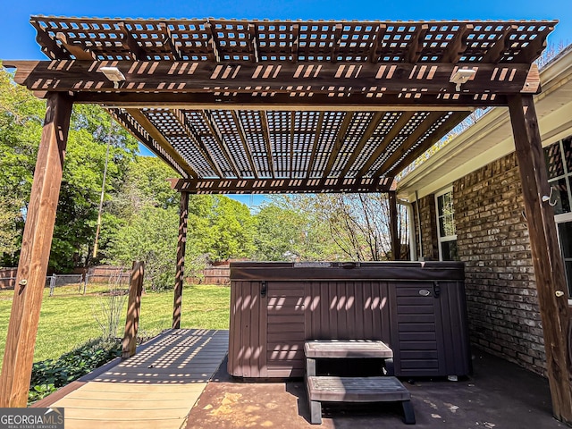 wooden deck featuring a yard, fence, and a hot tub