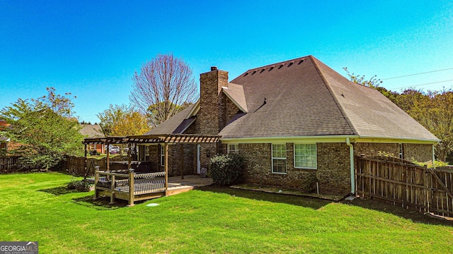 back of house with brick siding, a fenced backyard, a lawn, and a pergola