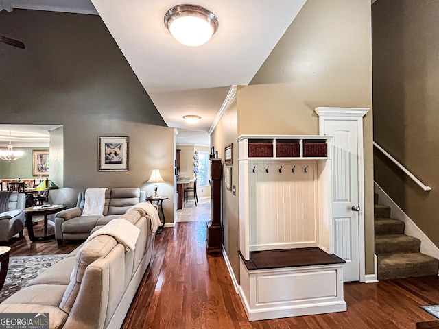 mudroom featuring dark wood-type flooring, baseboards, and an inviting chandelier