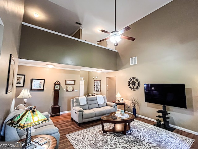living area featuring ceiling fan, visible vents, baseboards, and wood finished floors