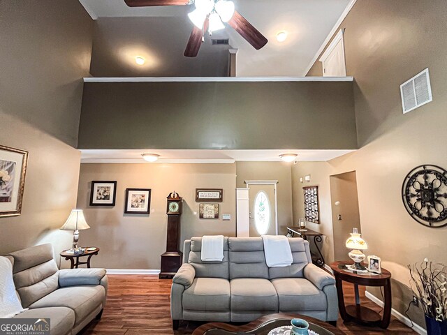 living room with wood finished floors, baseboards, a ceiling fan, and visible vents