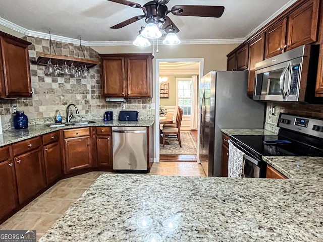 kitchen with crown molding, ceiling fan, a sink, and stainless steel appliances