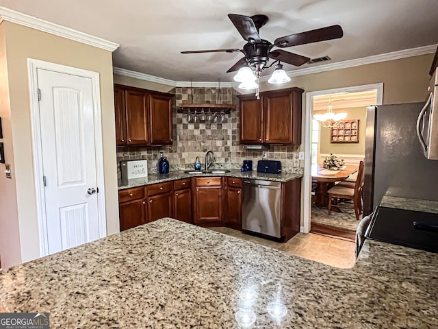 kitchen with tasteful backsplash, visible vents, appliances with stainless steel finishes, ceiling fan with notable chandelier, and a sink