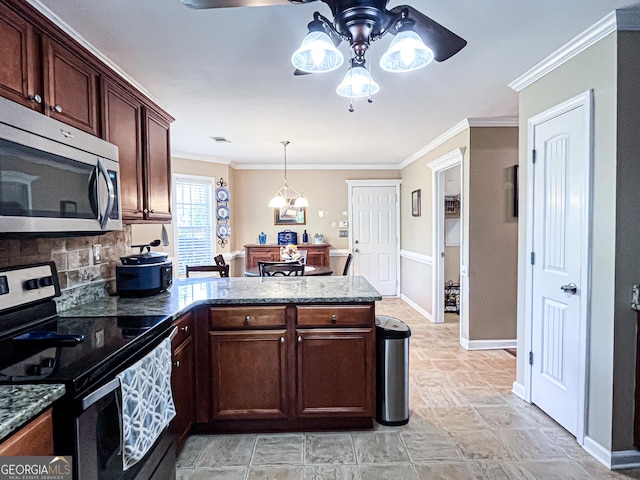 kitchen with a peninsula, a ceiling fan, dark stone countertops, appliances with stainless steel finishes, and decorative backsplash