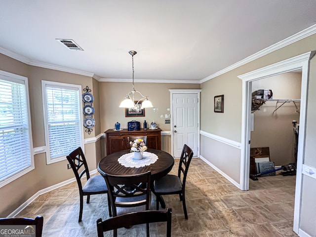dining space with baseboards, ornamental molding, and visible vents