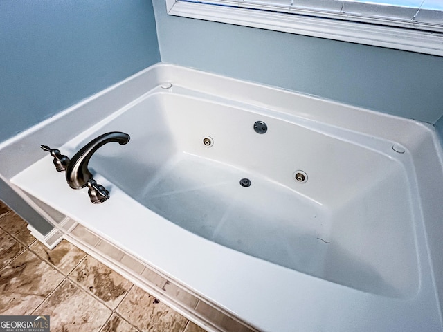 bathroom featuring a tub with jets
