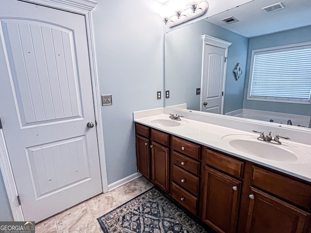 bathroom with a sink, visible vents, and double vanity