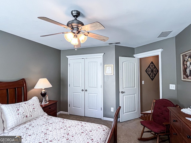 carpeted bedroom featuring visible vents, baseboards, a ceiling fan, and a closet