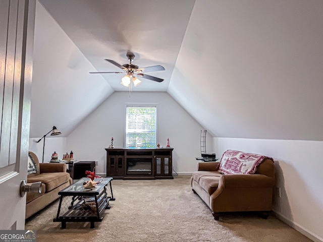 carpeted living area with ceiling fan and lofted ceiling