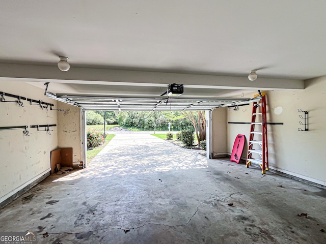 garage with a garage door opener and baseboards
