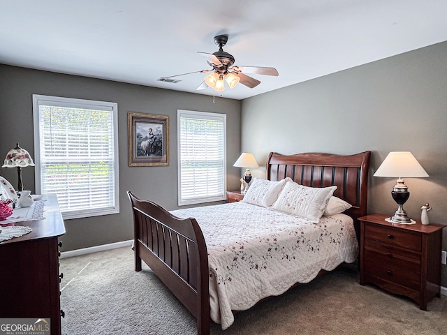 carpeted bedroom with ceiling fan, baseboards, and visible vents
