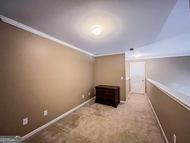 interior space featuring carpet flooring, baseboards, ornamental molding, and visible vents