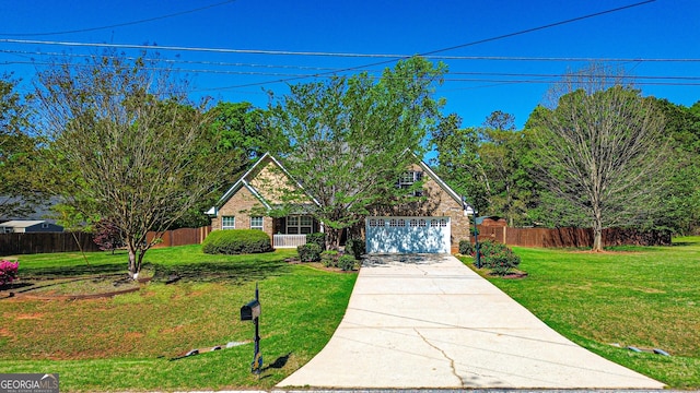 traditional-style home featuring concrete driveway, a front yard, fence, and a garage