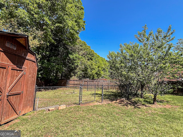 view of yard with an outdoor structure and fence