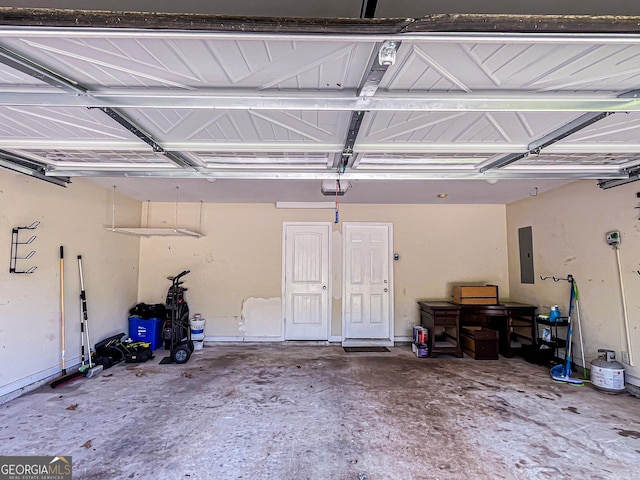 garage featuring a garage door opener and electric panel