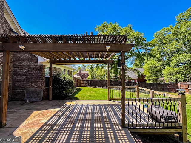 wooden deck featuring a patio, a yard, a pergola, and a fenced backyard