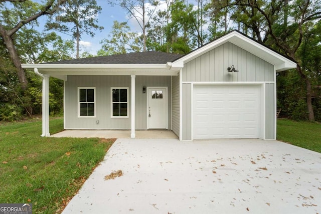 single story home with a garage, a front yard, and concrete driveway
