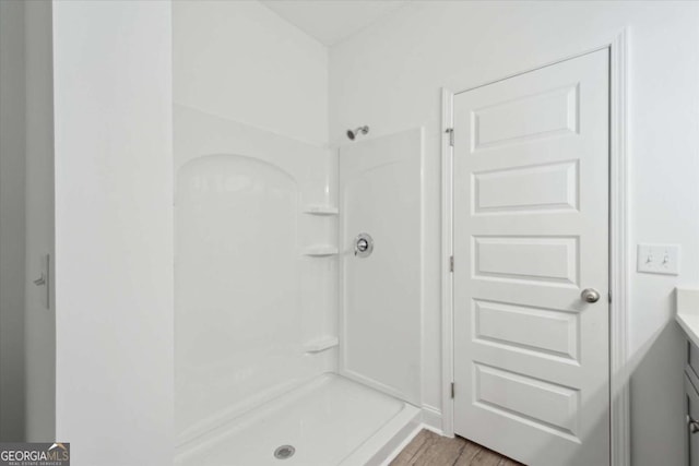 full bath featuring a shower and vanity