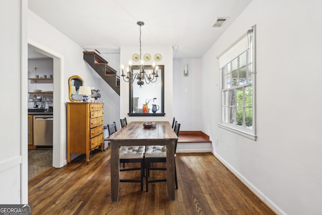 dining room with visible vents, baseboards, a chandelier, and wood finished floors
