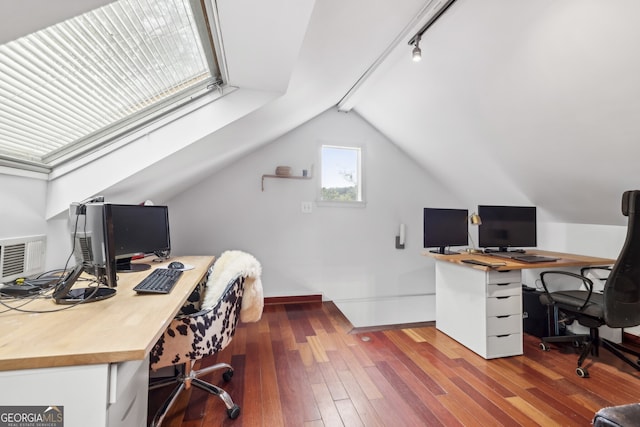 office space featuring baseboards, lofted ceiling, and hardwood / wood-style flooring