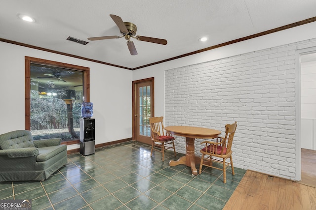 215 Cedar St, Anderson, SC 29626 - tiled dining space with brick wall, visible vents, baseboards, and ceiling fan